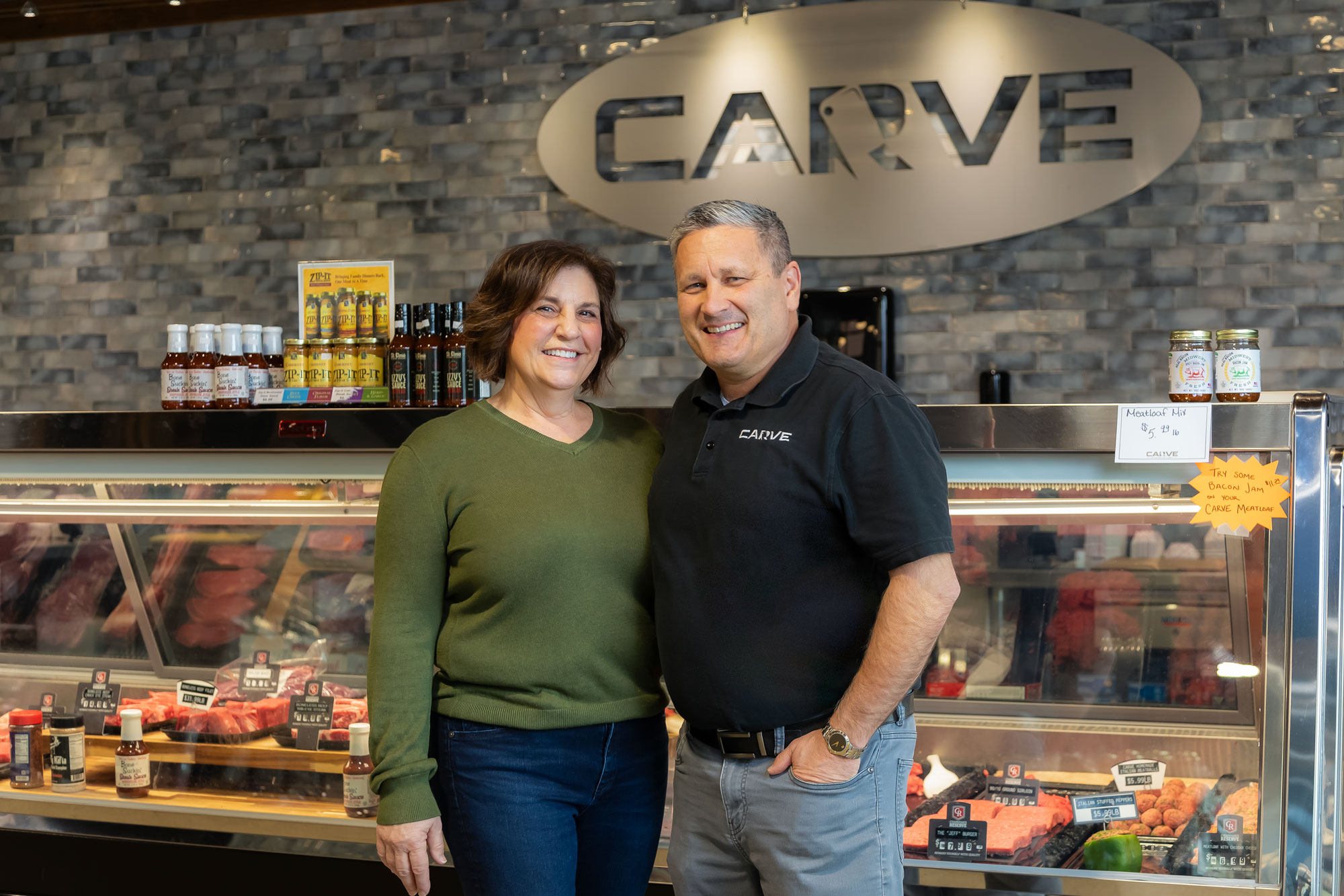 laurie and jeff kaiser in front of Carve Market counter