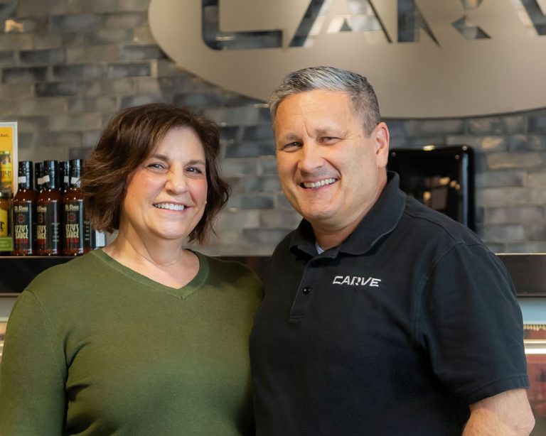 carve market laurie and jeff kaiser smiling in front of Carve Market counter